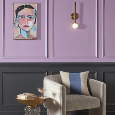 Top part of a wall painted in Novel Lilac with a side table and chair.